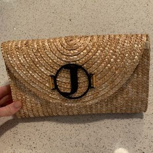 Woven straw clutch with black logo J